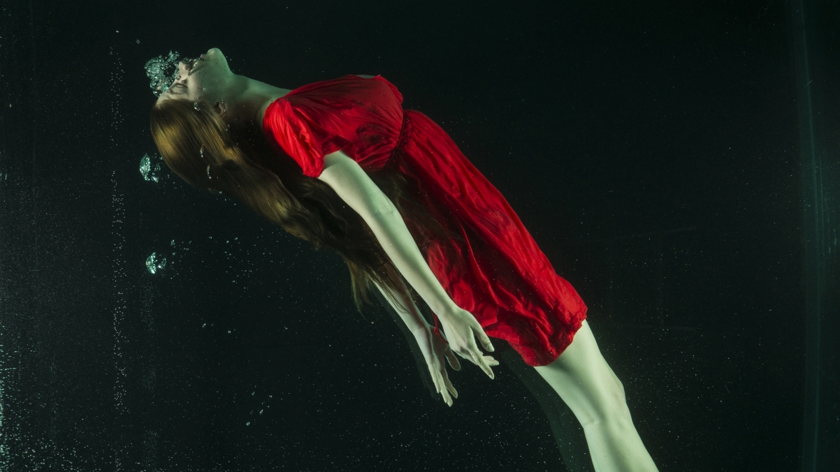 Underwater photography of girl in red