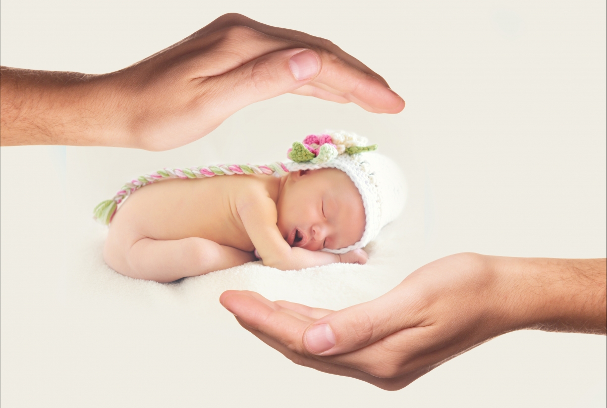 Picture of a baby being cared by hands